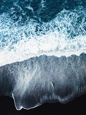 Ocean waves on a dark shoreline